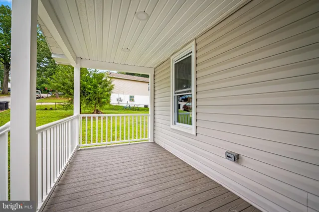 a view of a house with wooden deck
