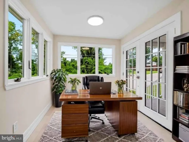 a living room with furniture and large windows