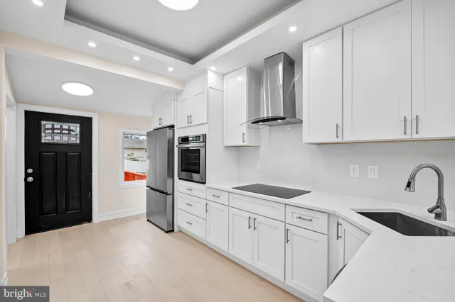 a kitchen with stainless steel appliances granite countertop a refrigerator and a sink