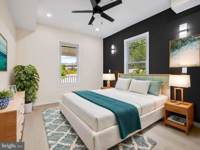 a view of an empty room with a window and a kitchen