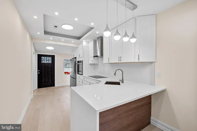 a kitchen with a sink a counter space and cabinets