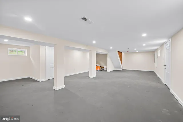 a balcony with wooden floor and trees in the back