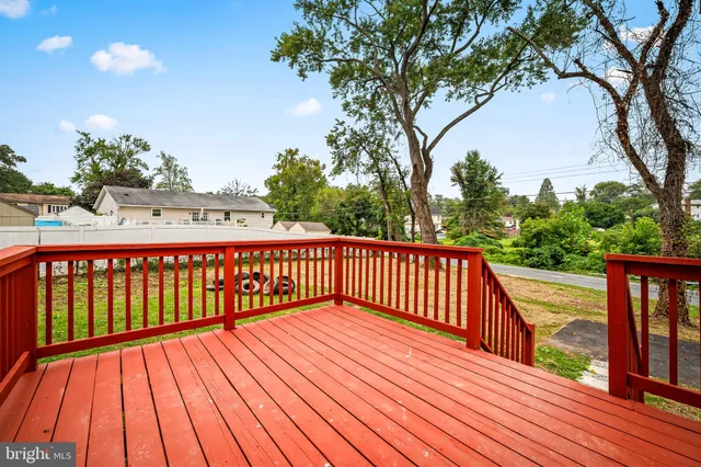 a balcony with wooden floor and fence