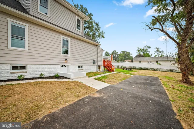 a white house with a yard and sitting area