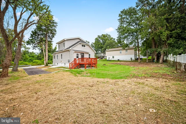 a view of a house with a yard and sitting area