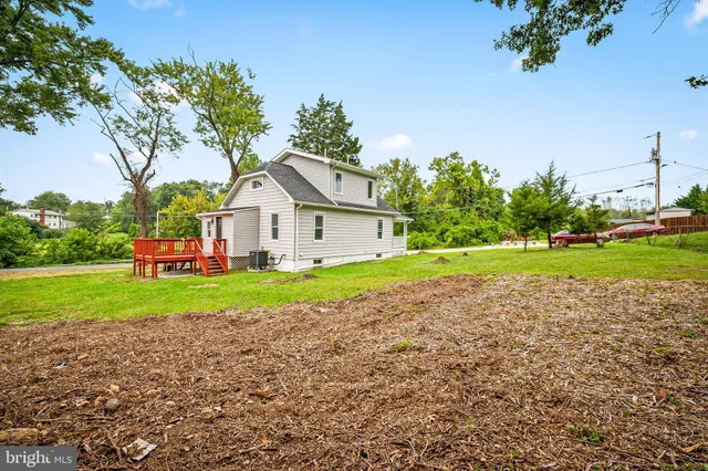 a view of yard with swimming pool and seating space