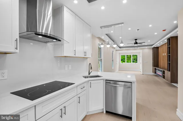 a kitchen with white cabinets and appliances