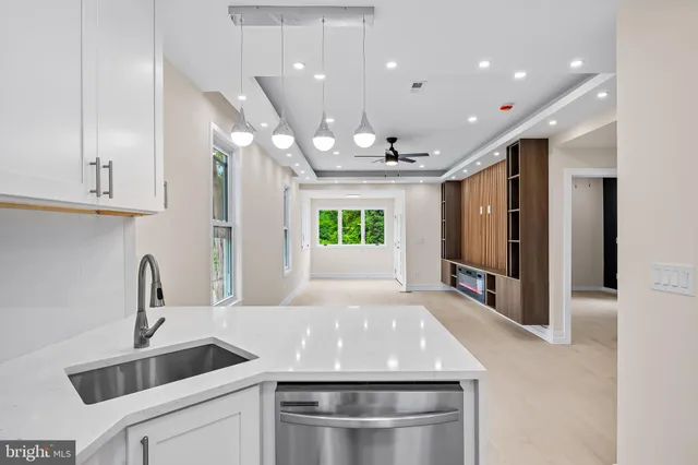 a kitchen with kitchen island a sink stainless steel appliances and window