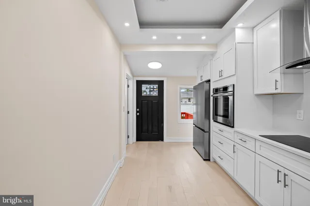 a hallway with white cabinets