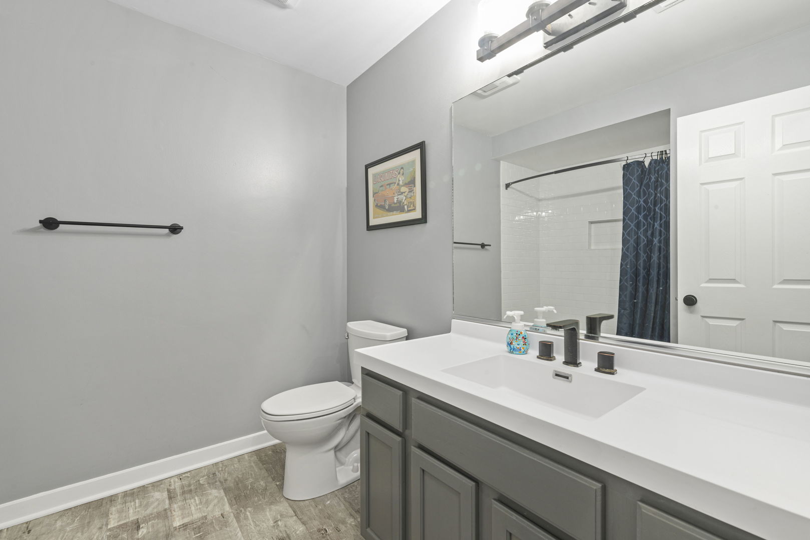 1940 Matthew Court, Unit D Elgin, IL 60123 - Photo 11 of 15 a bathroom with a sink a toilet and a mirror