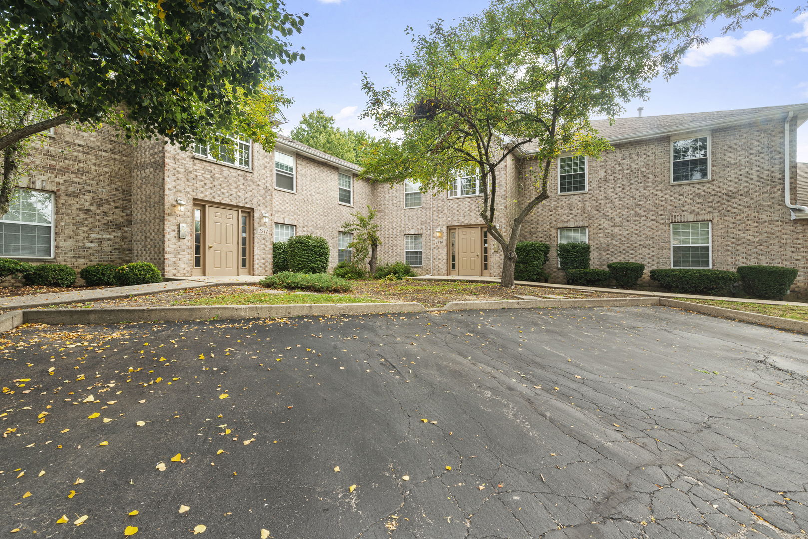 1940 Matthew Court, Unit D Elgin, IL 60123 - Photo 14 of 15 a front view of a house with a road