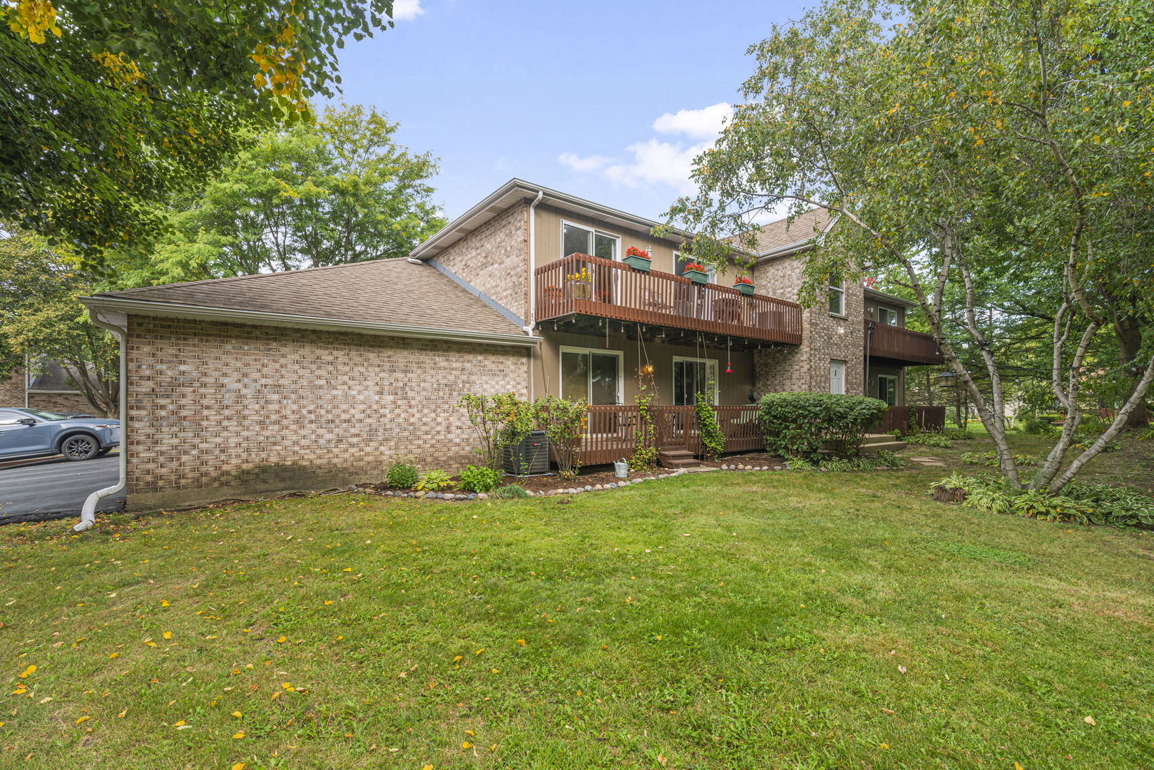 1940 Matthew Court, Unit D Elgin, IL 60123 - Photo 15 of 15 a view of a house with a yard and sitting area