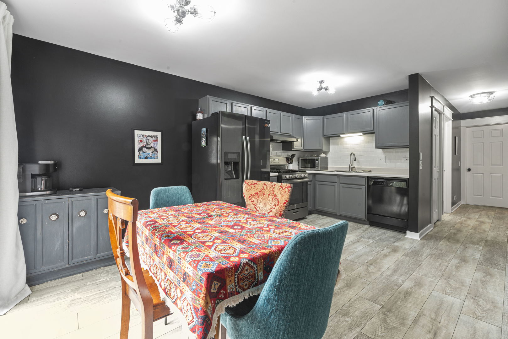 1940 Matthew Court, Unit D Elgin, IL 60123 - Photo 6 of 15 a large kitchen with a table and chairs
