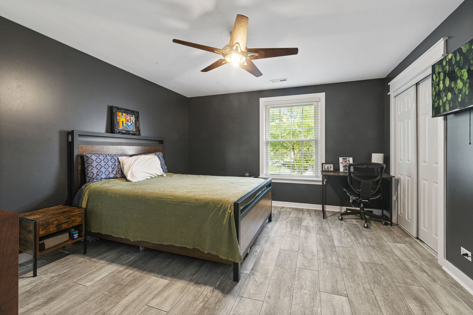 1940 Matthew Court, Unit D Elgin, IL 60123 - Photo 8 of 15 a bedroom with a bed and a chair