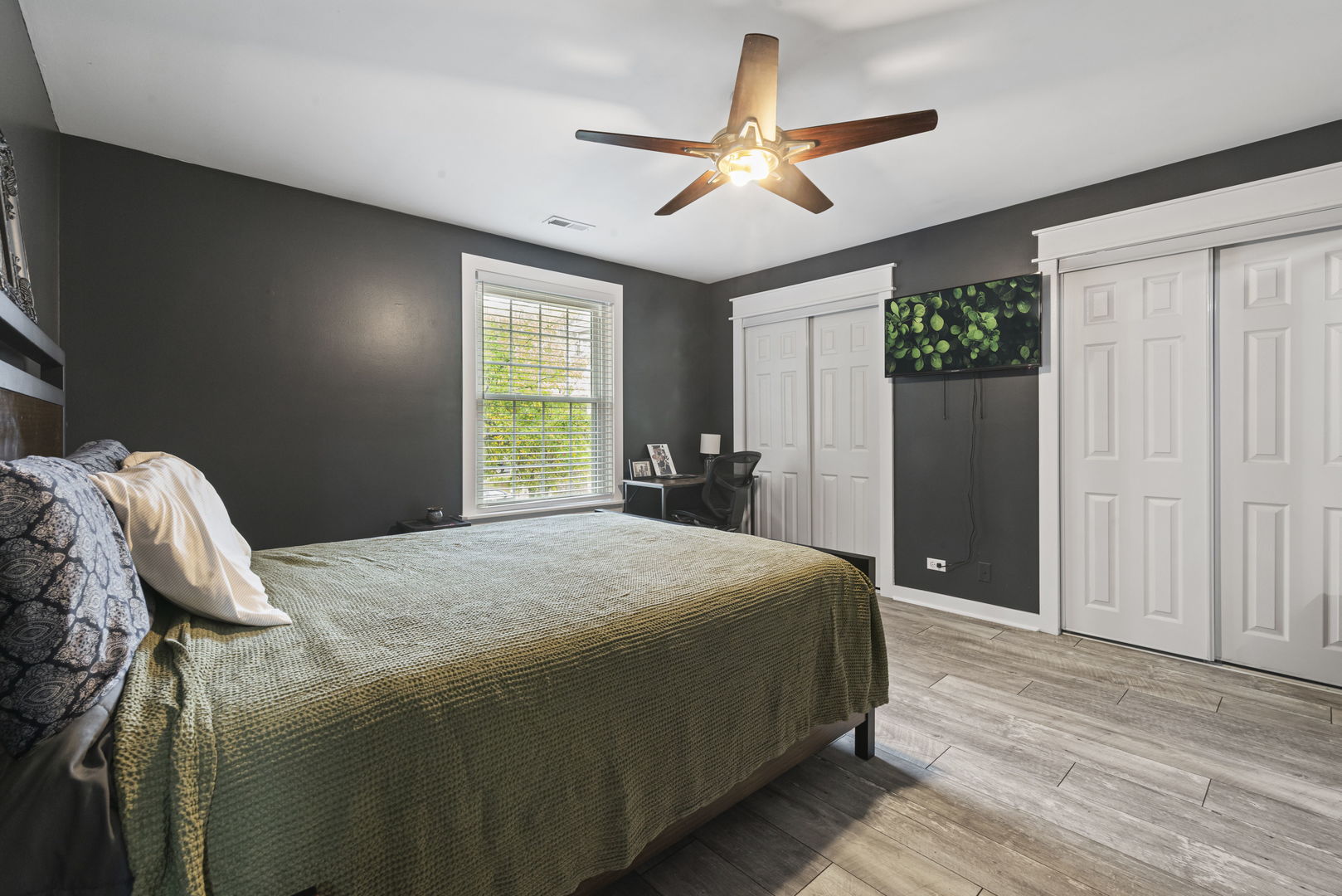 1940 Matthew Court, Unit D Elgin, IL 60123 - Photo 9 of 15 a bedroom with a bed and a large window