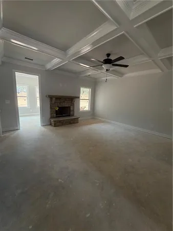 a view of an empty room with a fireplace and a chandelier