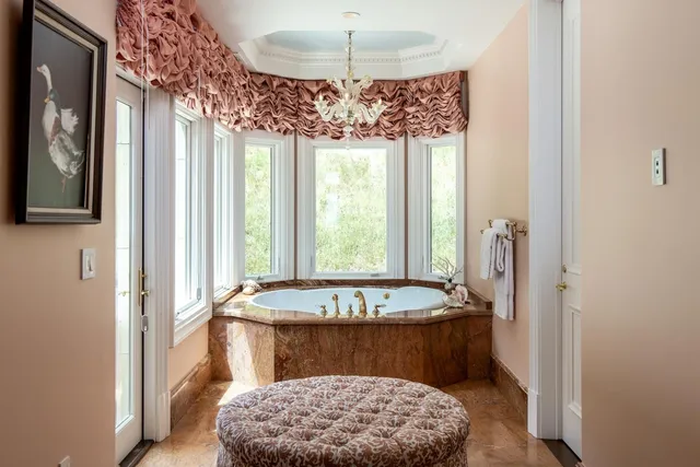a bathroom with a tub sink and window