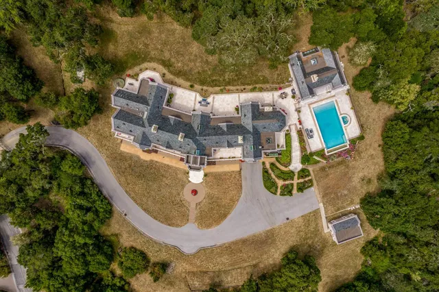 an aerial view of a house with outdoor space