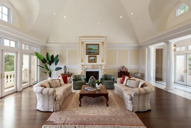 a living room with fireplace furniture and a large window