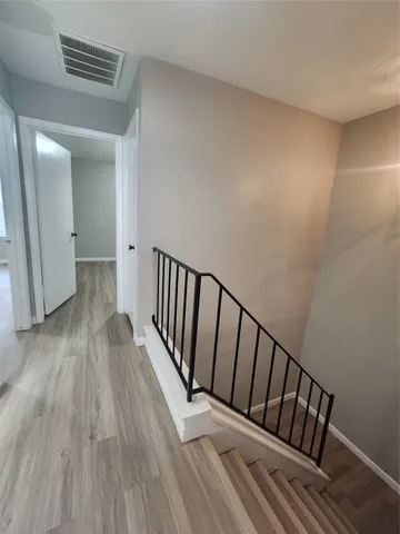 a view of hallway with wooden floor