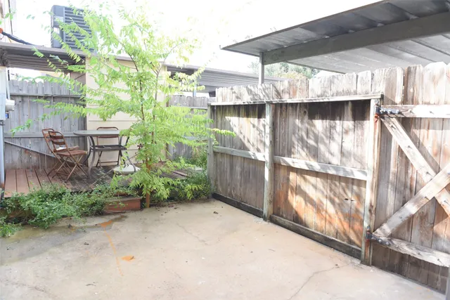 a view of backyard with outdoor seating and plants