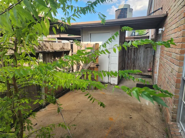 a backyard of a house with a garden and outdoor seating