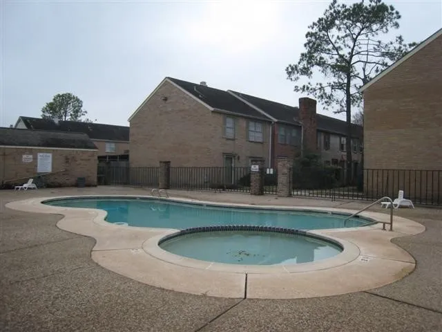 a view of house with a swimming pool