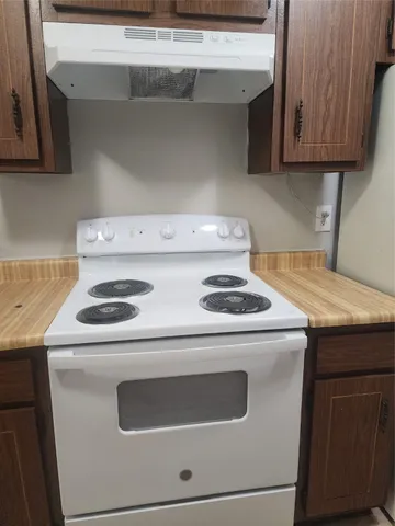 a stove top oven sitting inside of a kitchen