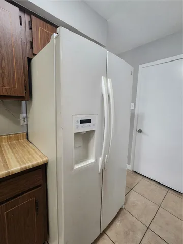 a view of a refrigerator a washer and dryer