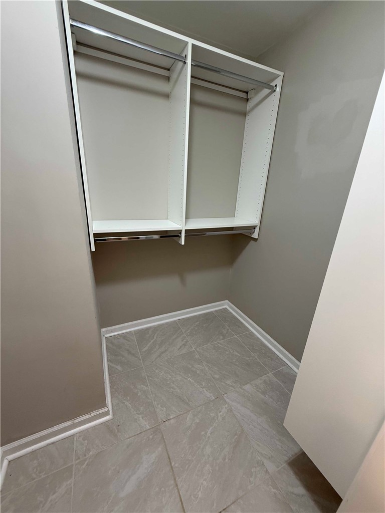 116 Kelly Lane Easley, SC 29642 - Photo 32 of 39 Tiled flooring pairs with structured shelving in this functional walk-in closet space.
