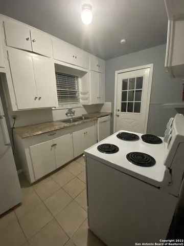 a kitchen with a sink stove and cabinets