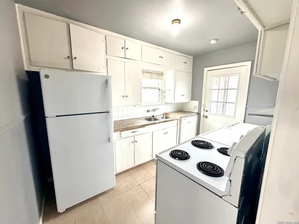 a kitchen with a refrigerator a stove a sink and a refrigerator