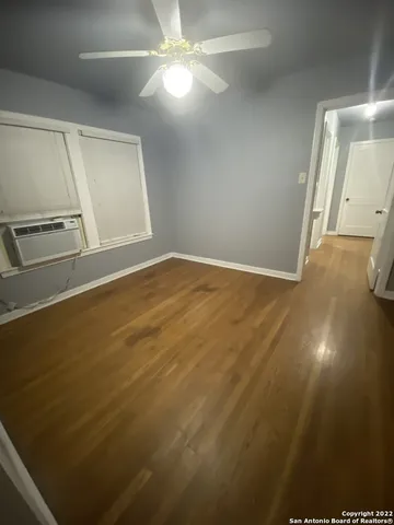 en empty room with wooden floor and cabinet