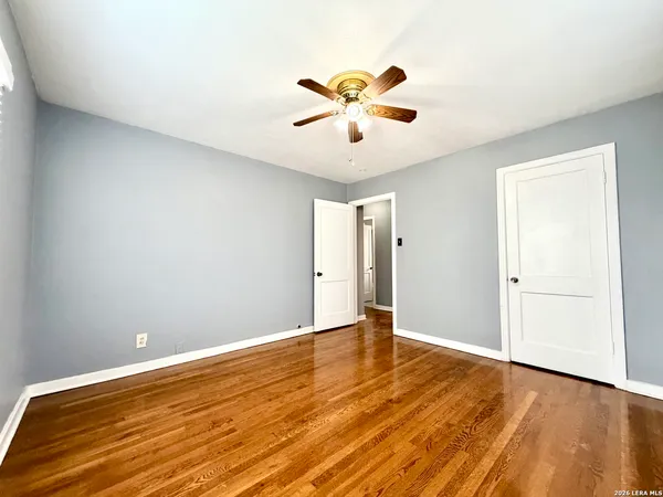 a view of an empty room with wooden floor