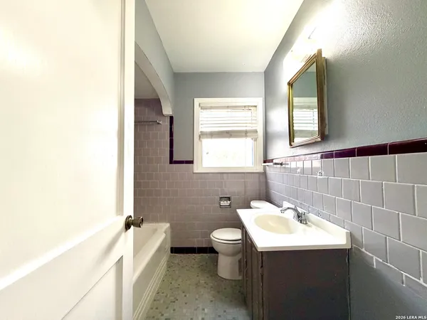 a bathroom with a sink toilet and mirror