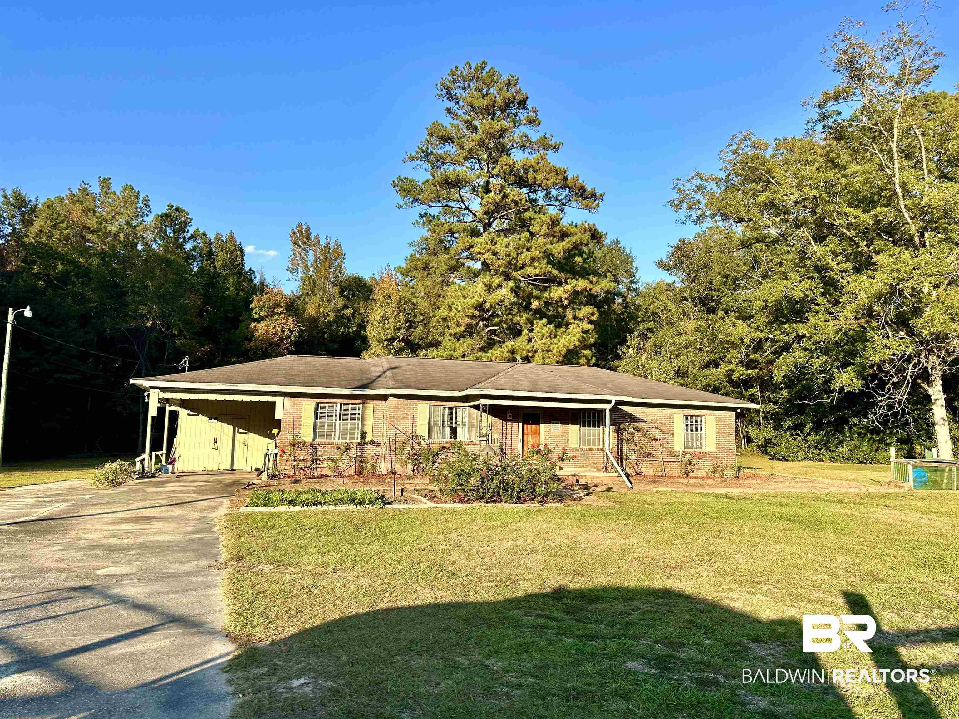 1206 St Nicholas Avenue Brewton, AL 36426 - Photo 1 of 19 Ranch-style house featuring a front yard and a carport