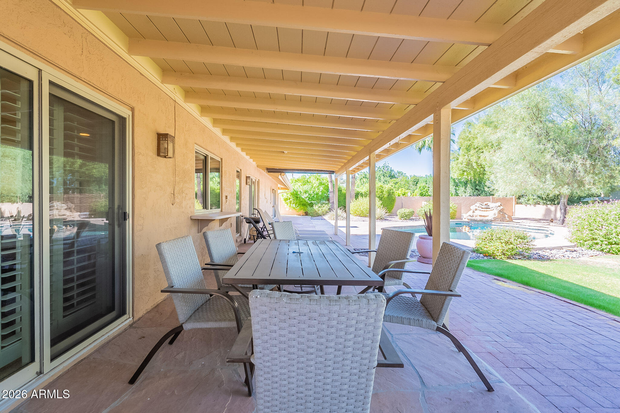 4226 East North Lane Phoenix, AZ 85028 - Photo 35 of 43 a view of a patio with table and chairs and floor to ceiling window with wooden floor