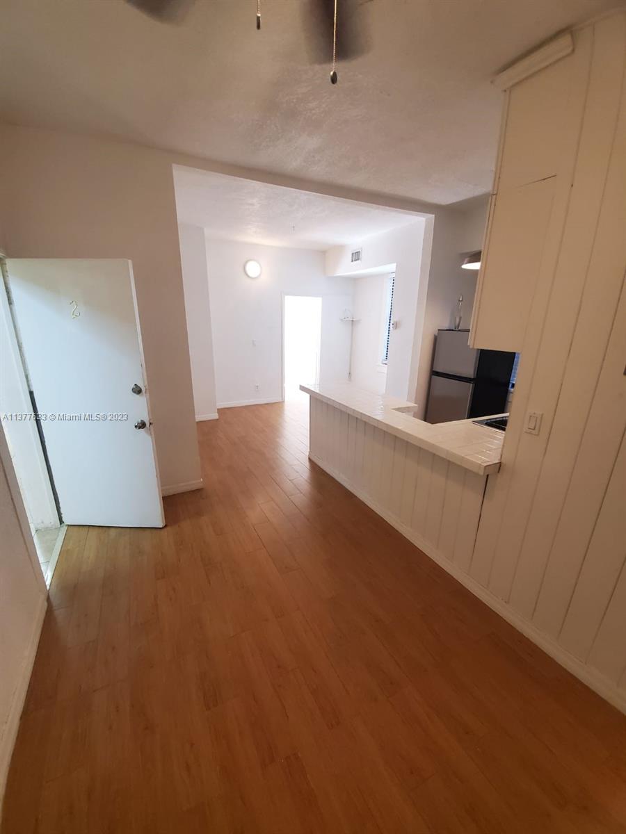 7149 Bay Drive, Unit 2 Miami Beach, FL 33141 - Photo 6 of 15 a view of a furniture and an empty room with wooden floor