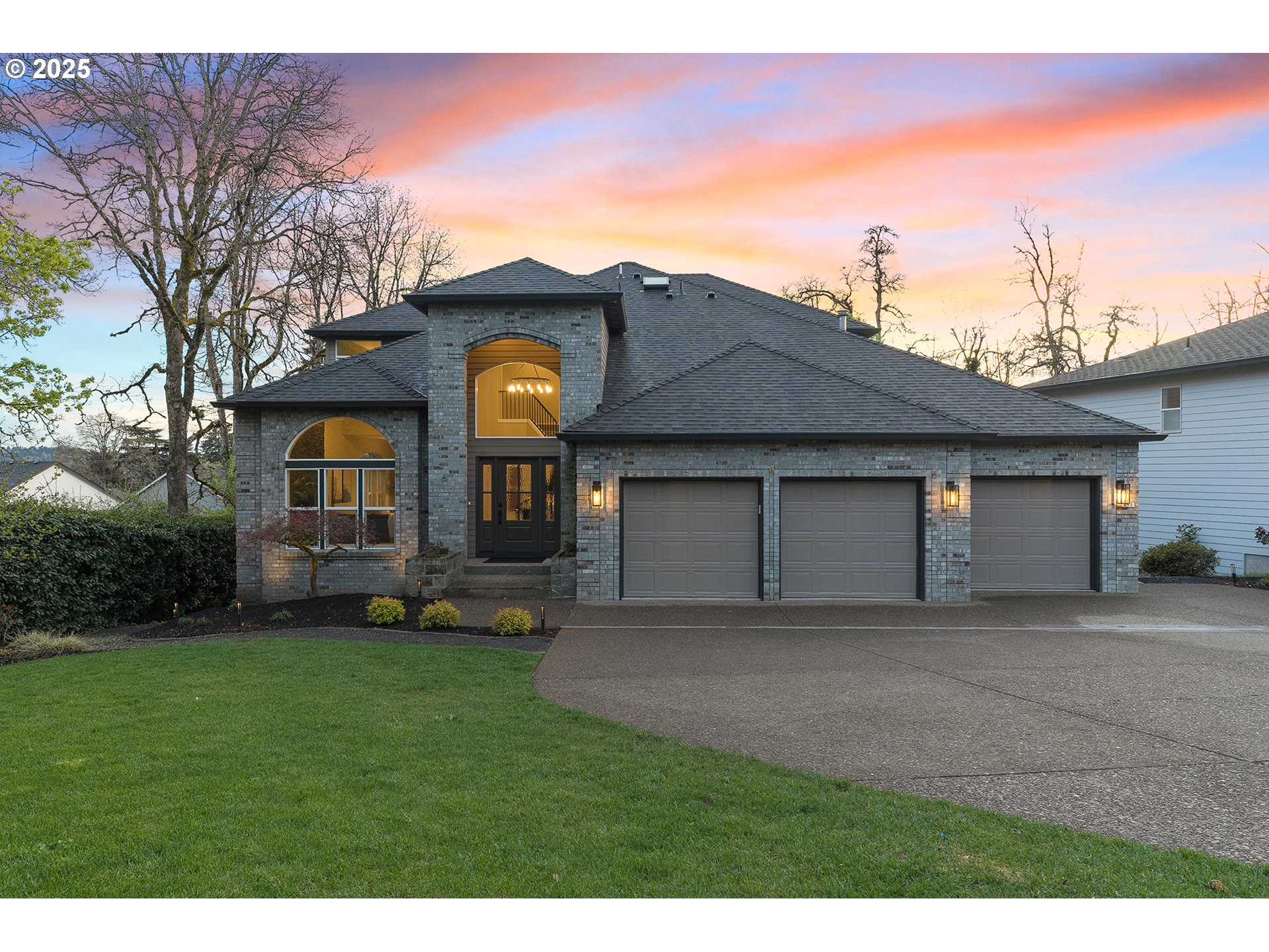 a front view of a house with a yard and garage