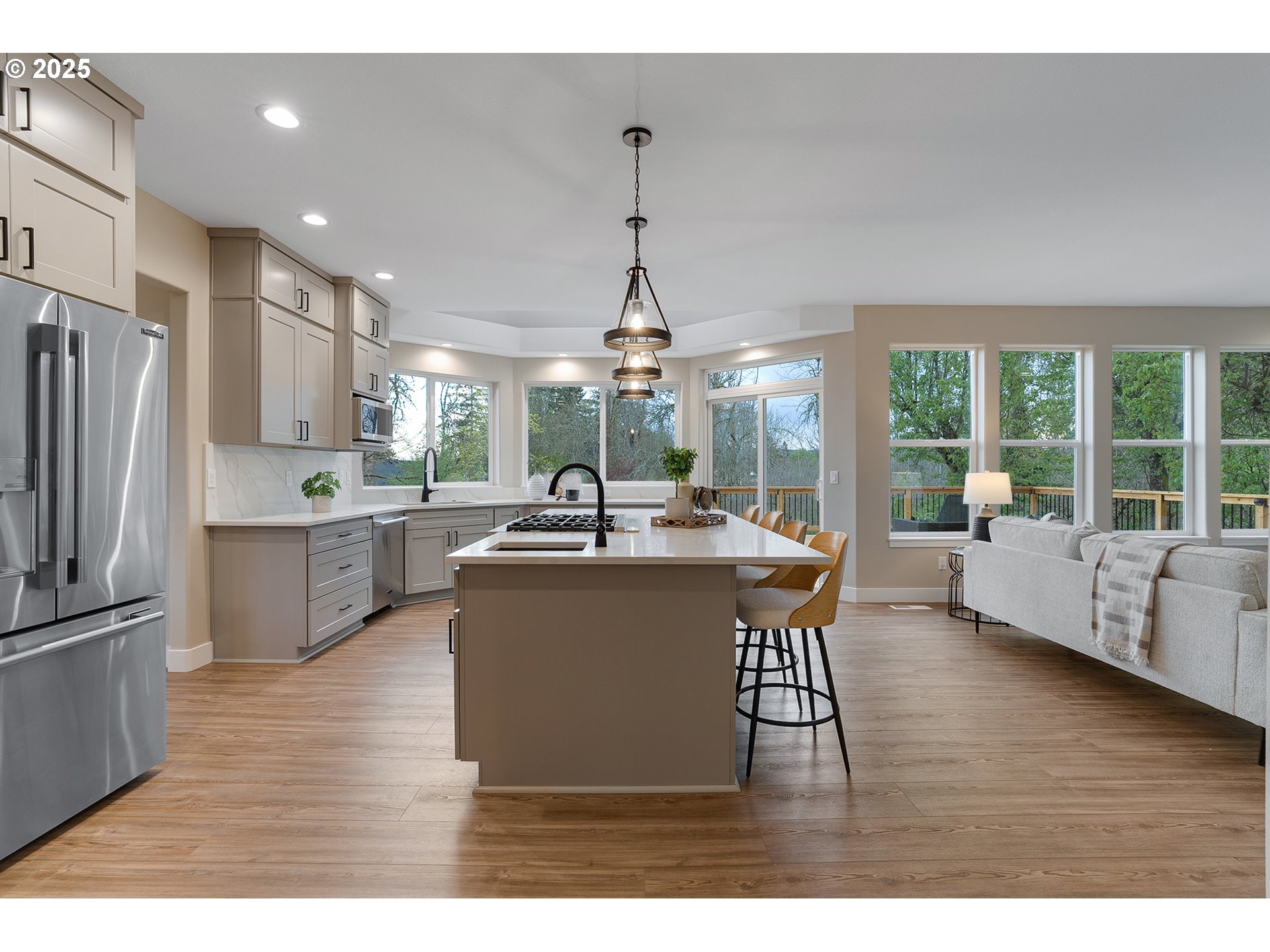 655 Barbary Place Gladstone, OR 97027 - Photo 11 of 48 a large kitchen with granite countertop a stove a sink dishwasher a refrigerator and cabinets with wooden floor