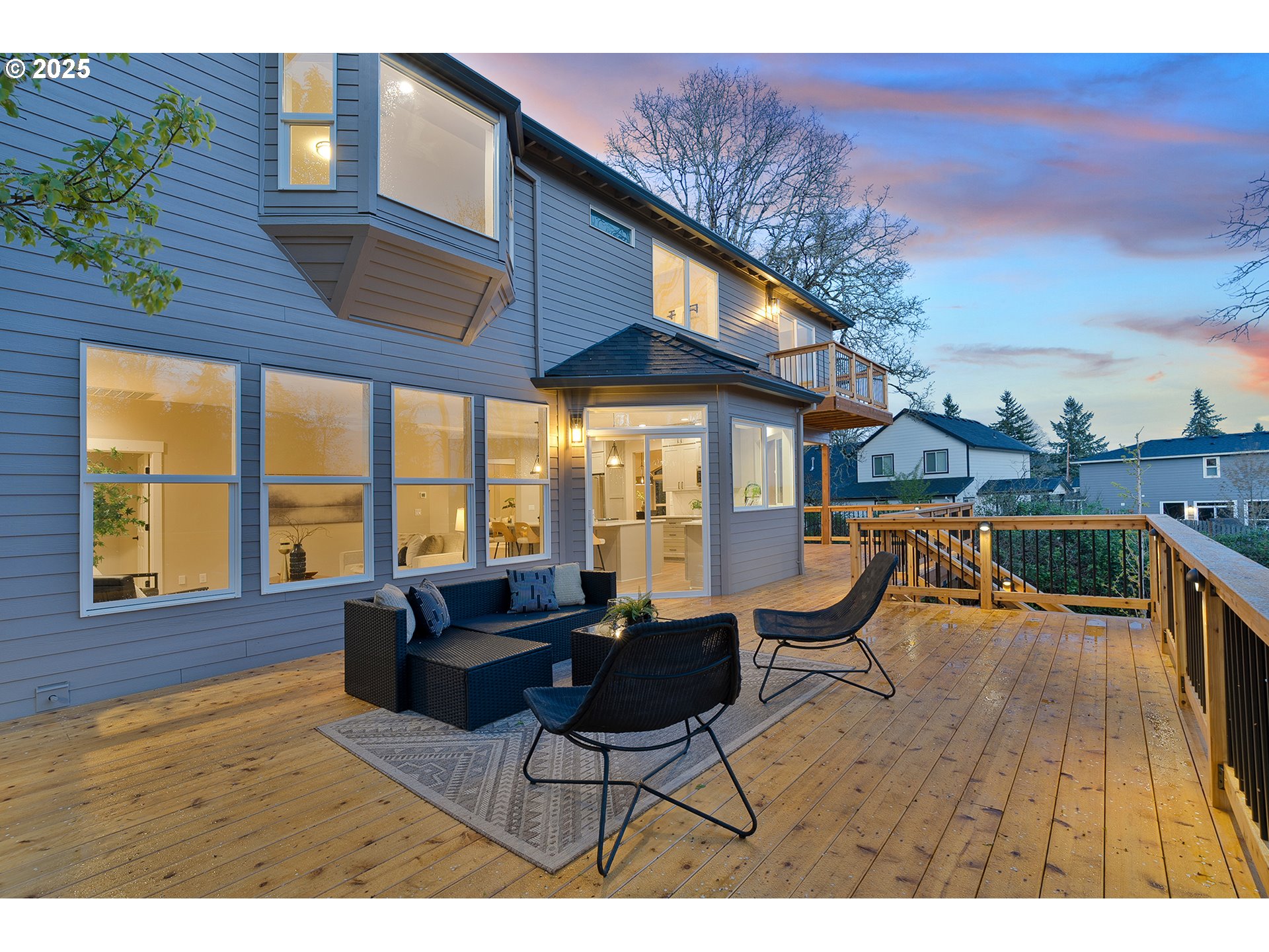 655 Barbary Place Gladstone, OR 97027 - Photo 36 of 48 a living room with furniture a wooden floor and a floor to ceiling window