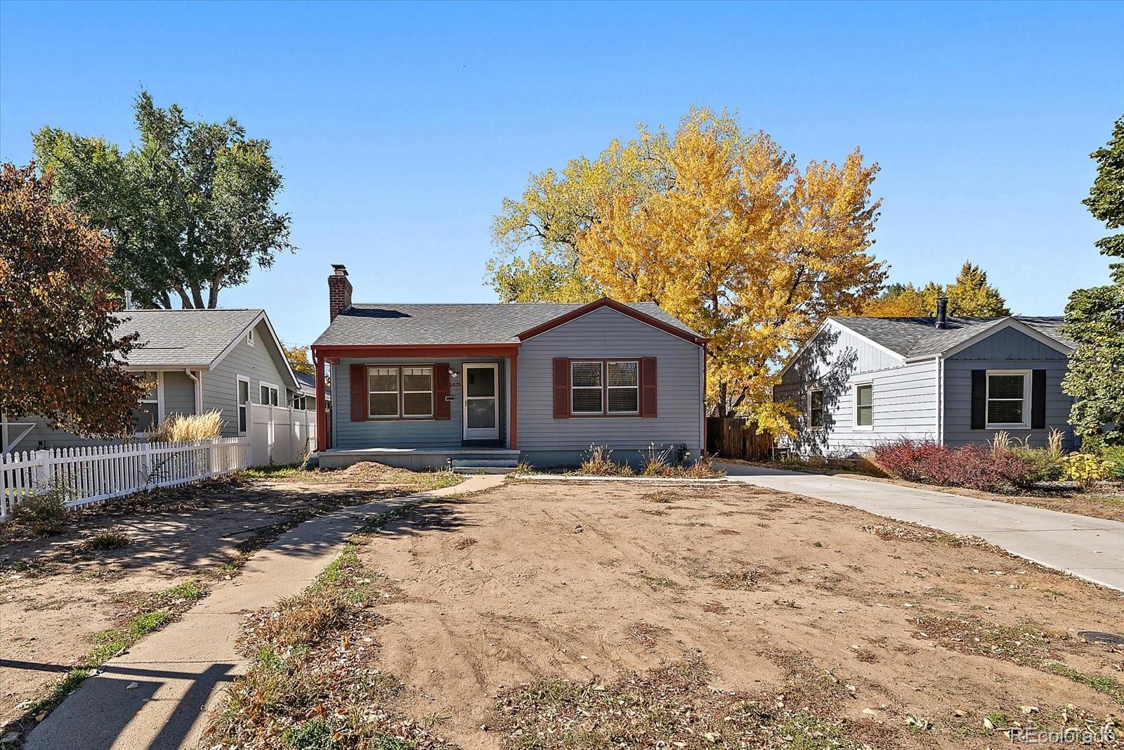 2575 South Lafayette Street Denver, CO 80210 - Photo 1 of 25 a front view of a house with a yard covered in snow