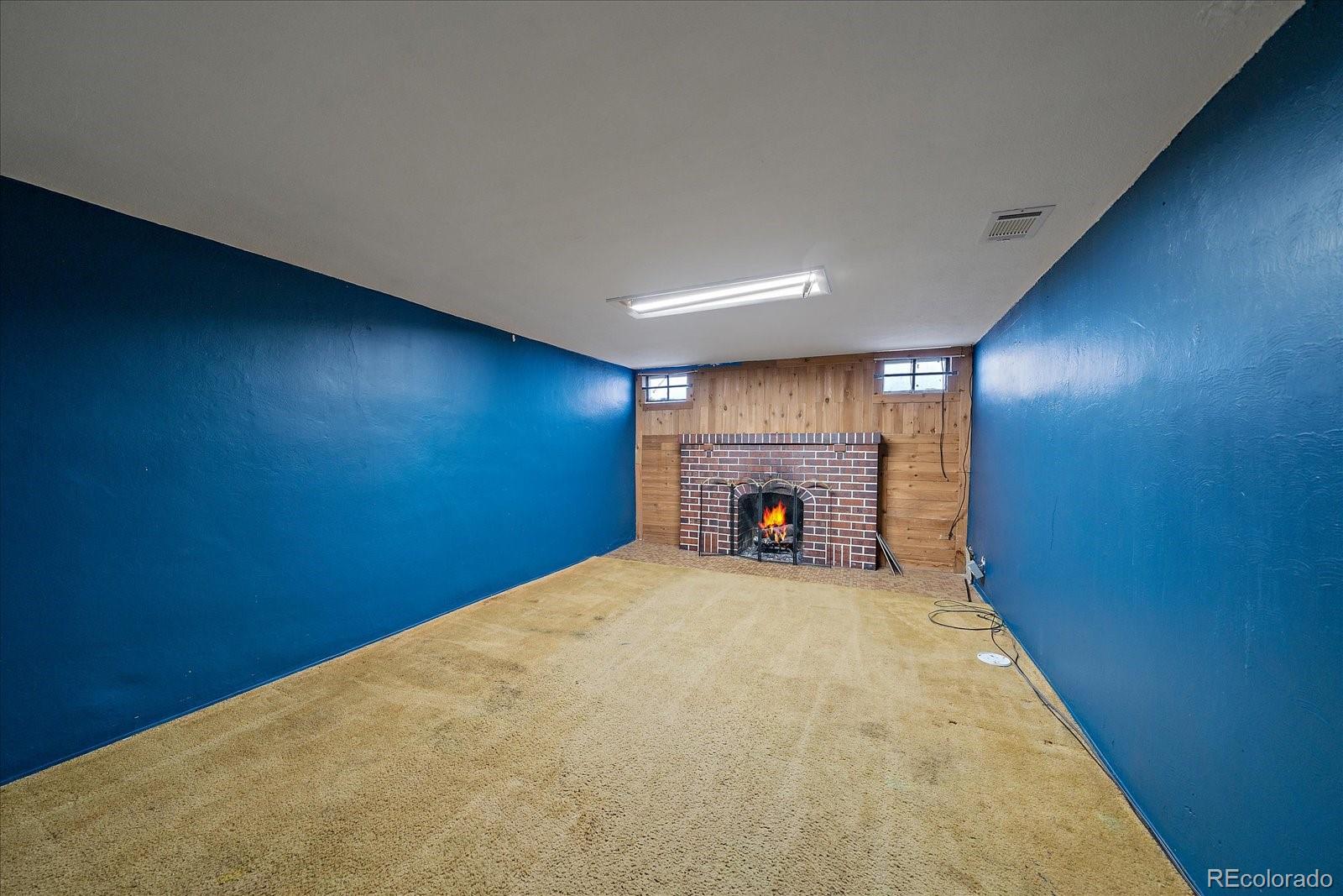 2575 South Lafayette Street Denver, CO 80210 - Photo 14 of 25 a view of an empty room with a fireplace
