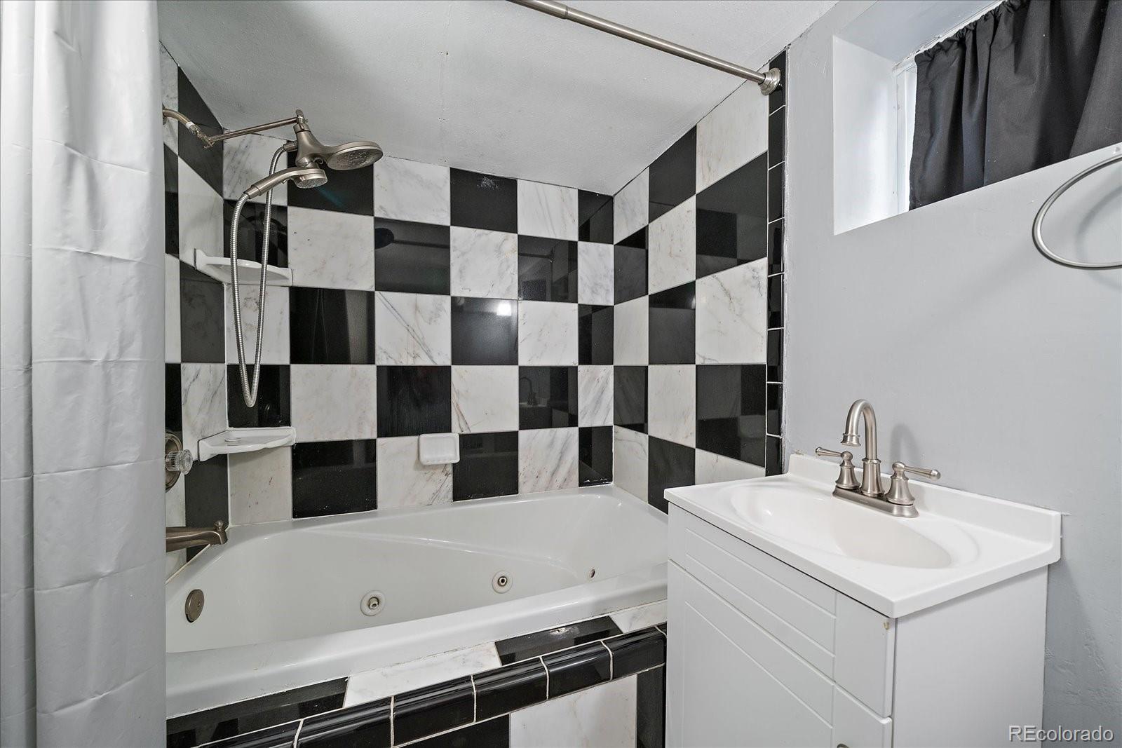 2575 South Lafayette Street Denver, CO 80210 - Photo 19 of 25 a bathroom with a bathtub and a sink