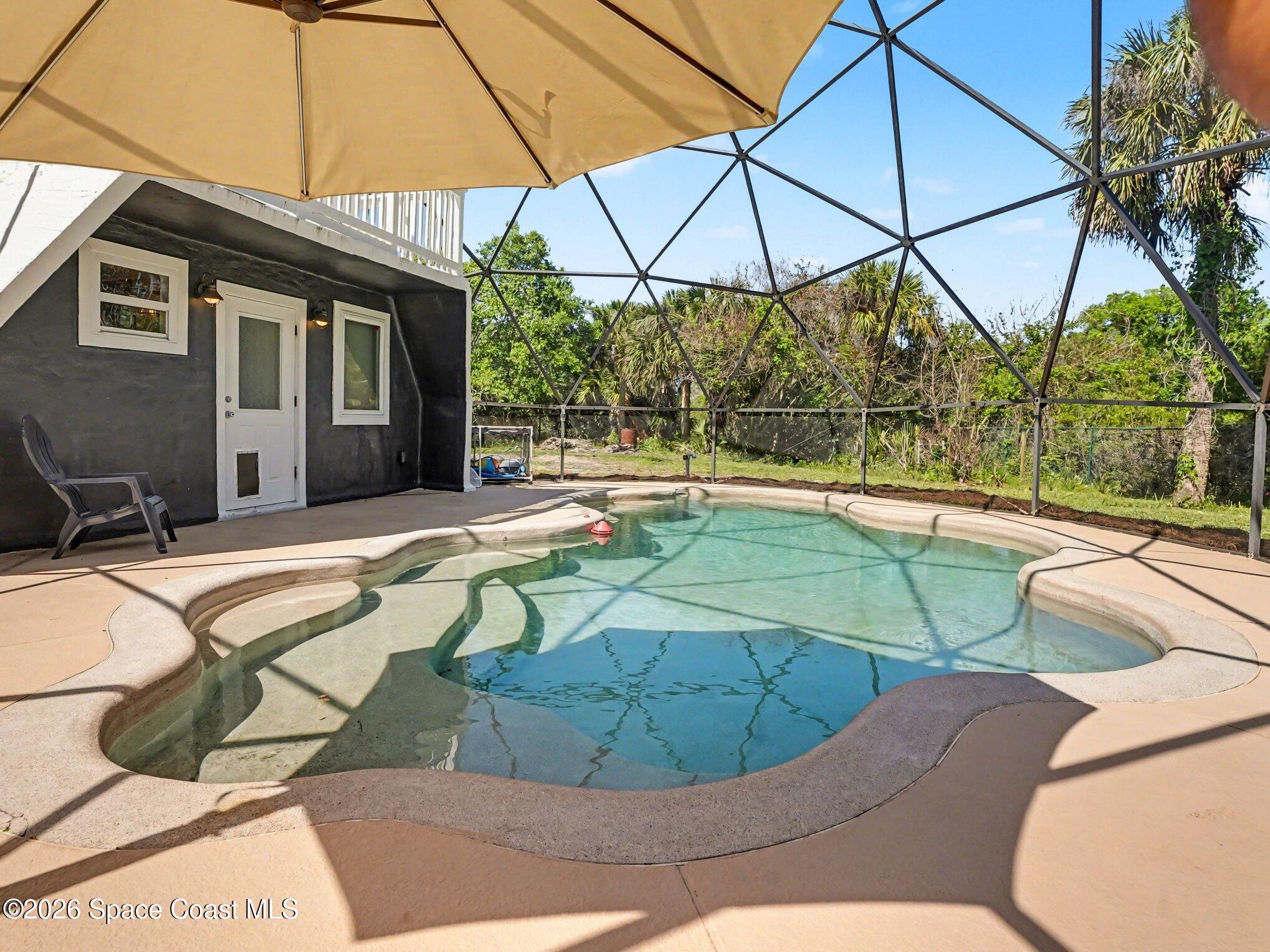 4045 Jake Avenue Cocoa, FL 32926 - Photo 14 of 35 a view of a swimming pool with a lounge chairs