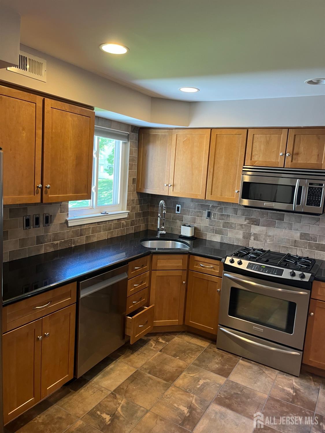 511 Chanticleer Cherry Hill, NJ 08003 - Photo 10 of 20 a kitchen with stainless steel appliances granite countertop a sink a stove and a microwave
