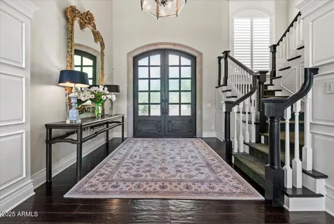 a front view of a house with a yard and trees