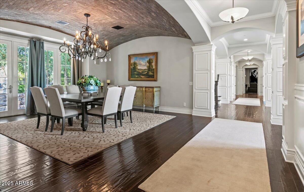 2205 East Colter Street Phoenix, AZ 85016 - Photo 16 of 59 a dining room with wooden floor a chandelier a wooden table and chairs