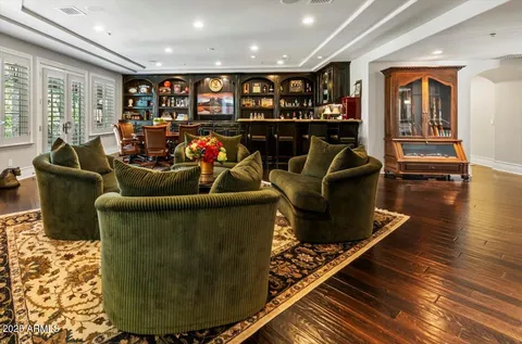 a view of a patio with dining table and chairs with wooden floor and fence