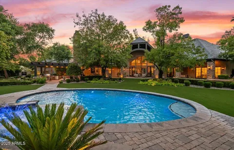 a big yard with lots of green space and trees in the background